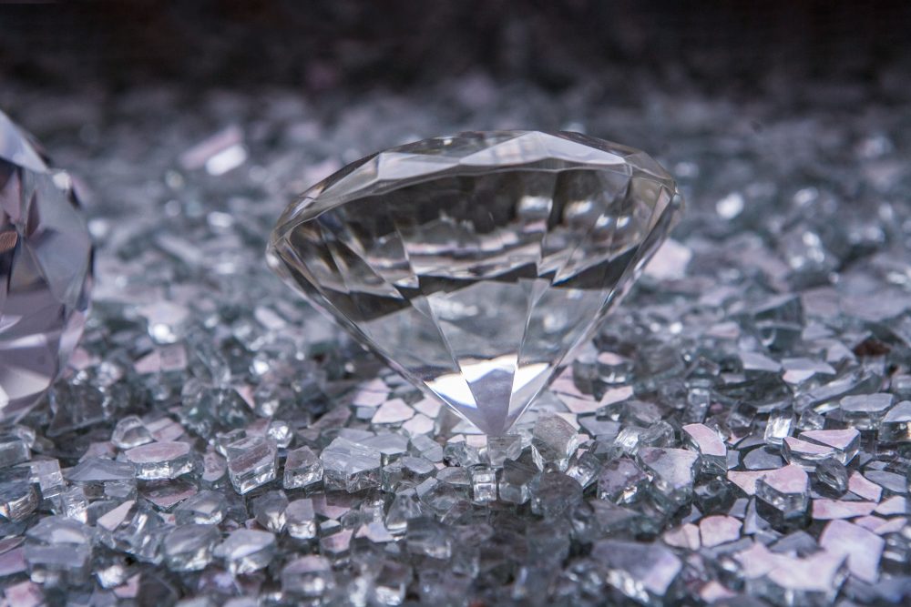 Are diamonds a good investment - A couple of diamonds sitting on top of a table.